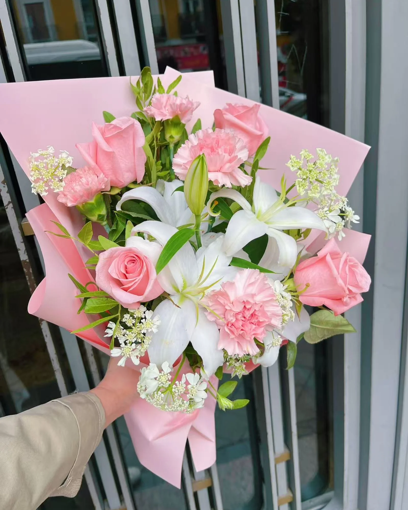 Ternura bouquet of dusty-pink roses and carnations with white lilies in pink Korean paper